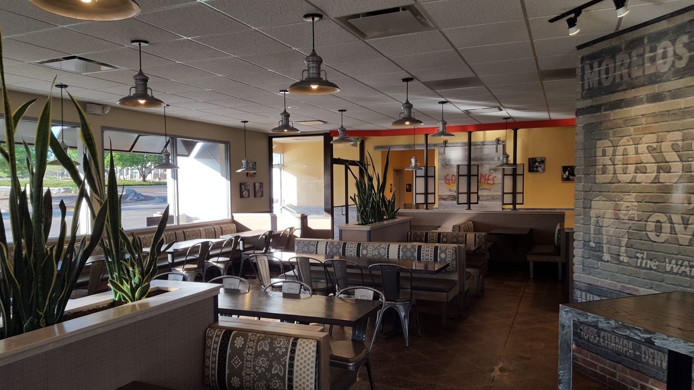 A restaurant with a lot of tables and chairs in it