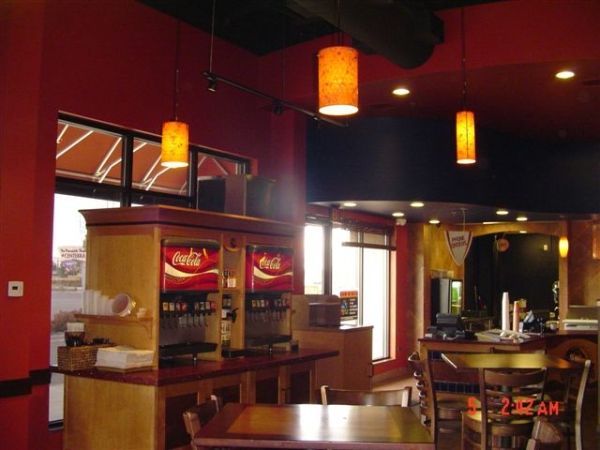 The inside of a restaurant with coca cola vending machines