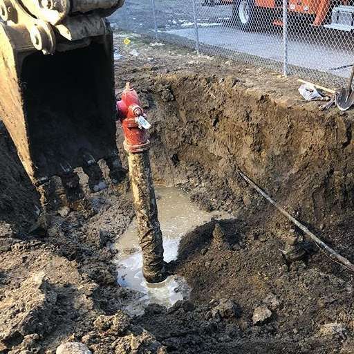 A red pipe in a muddy hole