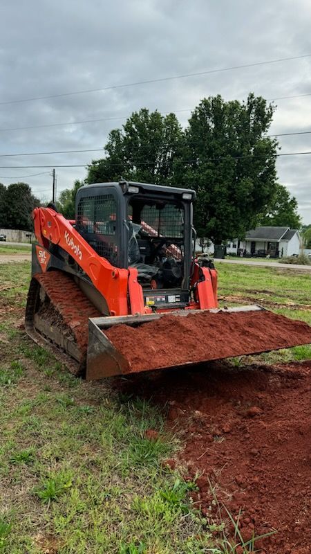 A bulldozer is moving dirt in a field.