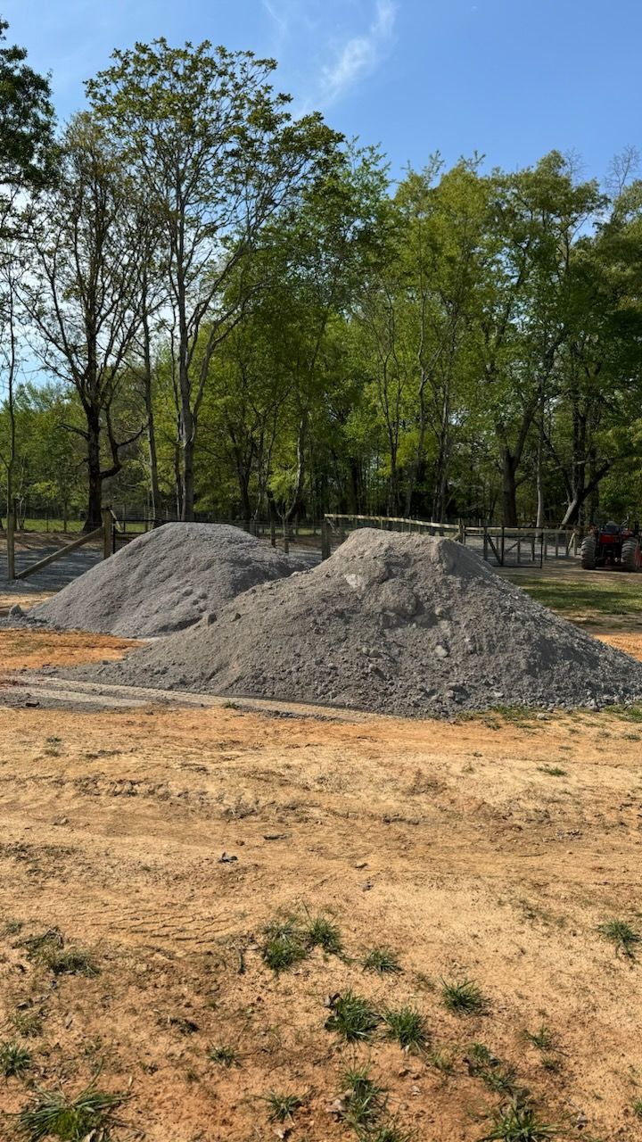 A pile of dirt is sitting in the middle of a dirt field.