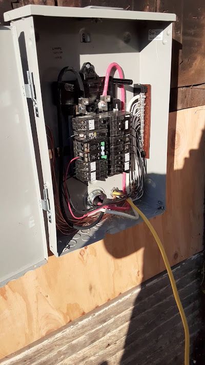 A man wearing a mask is standing in a doorway.