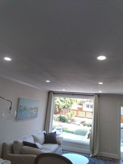 A light fixture is hanging from the ceiling in a dark room.