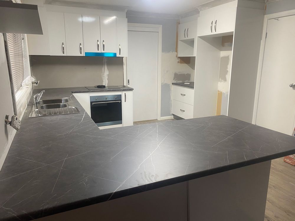 Kitchen with a Black Countertop and White Cabinets — 4Shaw Kitchens in Dubbo, NSW