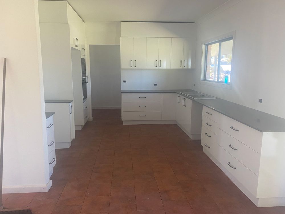 Spacious Kitchen with White Cabinets and Window — 4Shaw Kitchens in Dubbo, NSW