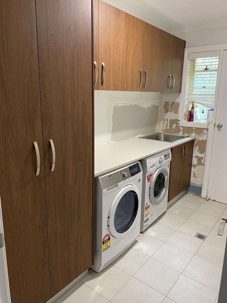A Laundry Room with a Washing Machine and Dryer — 4Shaw Kitchens in Dubbo, NSW
