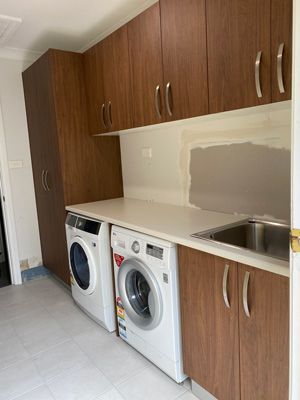 A Laundry Room with a Washer and Dryer and a Sink — 4Shaw Kitchens in Dubbo, NSW