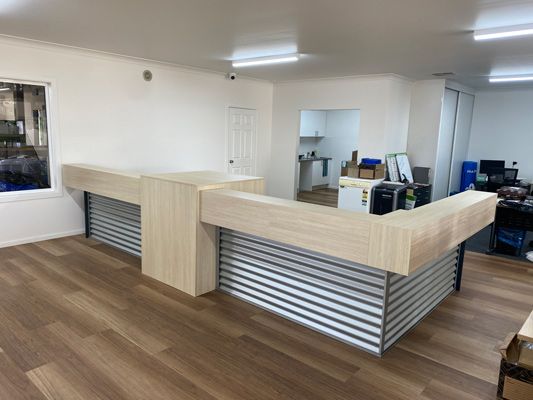 a Large Room with a Wooden Counter in the Middle of It — 4Shaw Kitchens in Dubbo, NSW