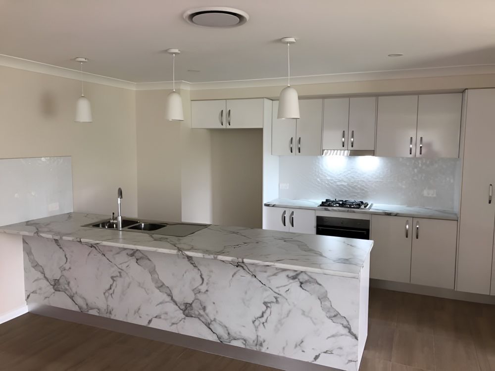 A Kitchen With White Cabinets and a Marble Counter Top — 4Shaw Kitchens in Coonamble, NSW