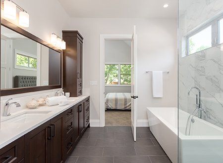 Bathroom Countertops — Bathroom Interior With Dark Hardwood Cabinets And Tile Floor In Asheville, NC