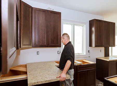 Kitchen Renovation — Contractor Installing A New Laminate Kitchen Counter Top in Asheville, NC