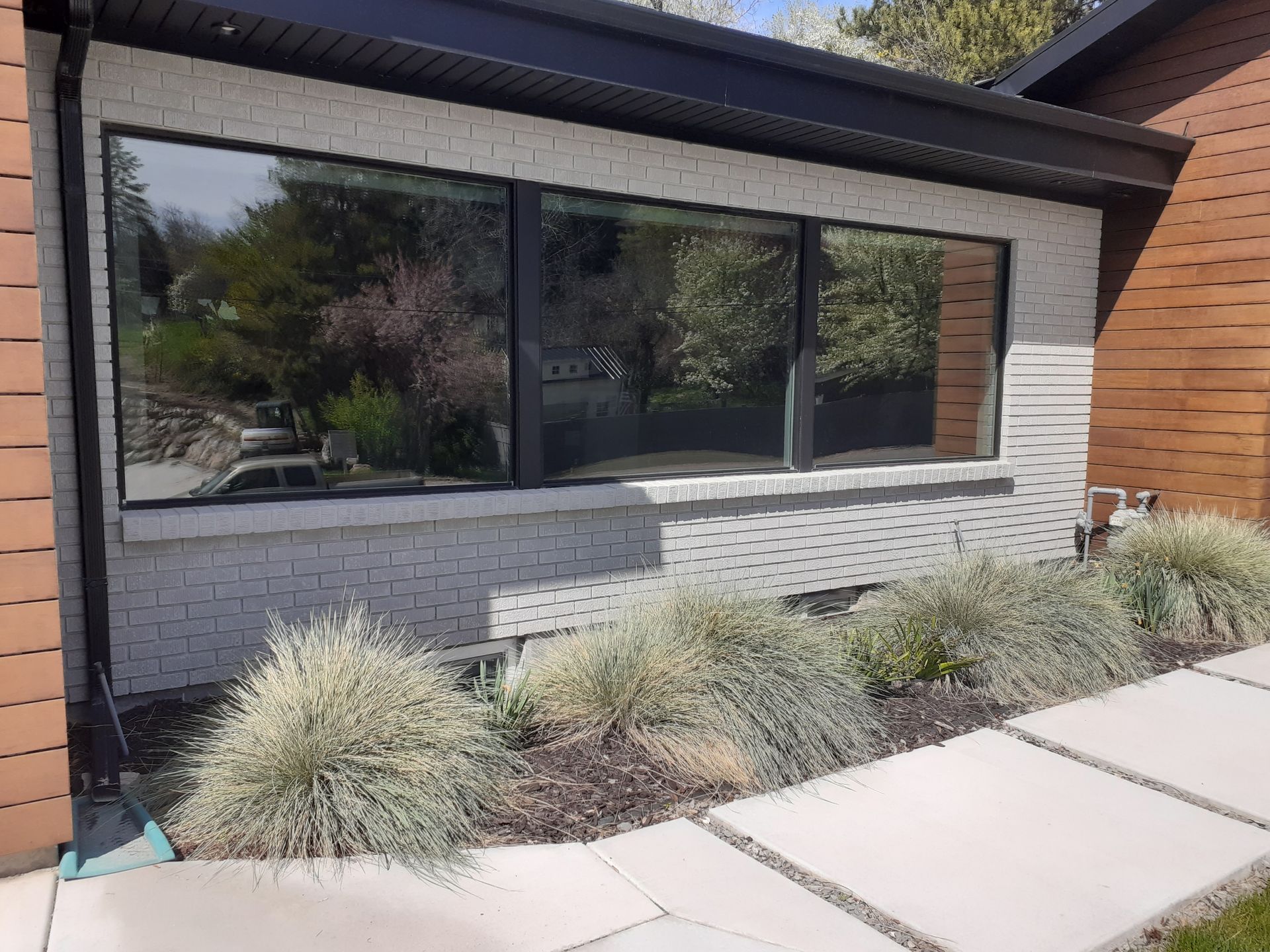 A brown house with a triangle shaped window