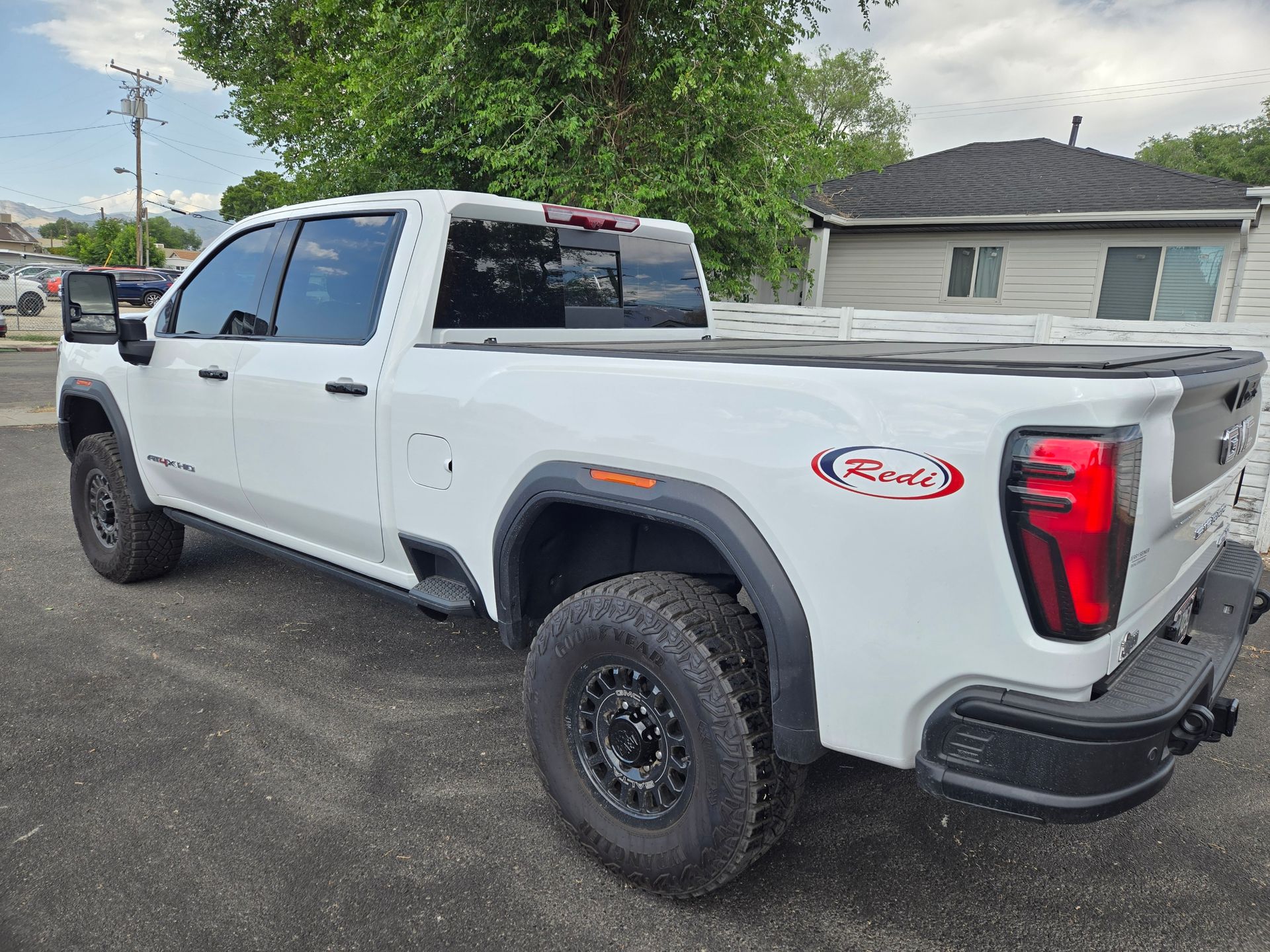 A brown house with a triangle shaped window