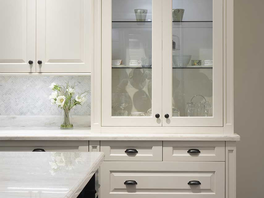 Glass fronted cabinets with drawers beneath