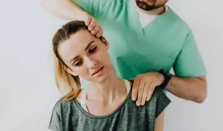 A man is giving a woman a neck massage.