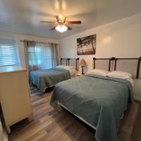 A bedroom with two beds and a ceiling fan.