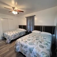 A bedroom with two beds and a ceiling fan.