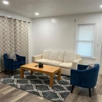 A living room with a couch , chairs , coffee table and rug.