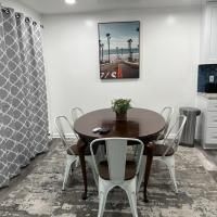 A dining room with a table and chairs and a picture on the wall.