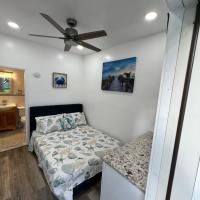 A bedroom with a bed and a ceiling fan.