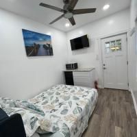 A bedroom with a bed , television and ceiling fan.