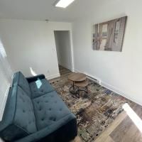 A living room with a couch , table and rug.