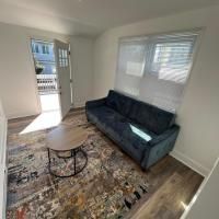 A living room with a couch , coffee table , and rug.