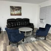 A living room with a couch , chairs , and a table.