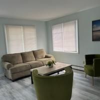 A living room with a couch , chairs , and a coffee table.