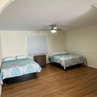 A bedroom with two beds and a ceiling fan.