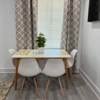 A dining room table and chairs in front of a window.