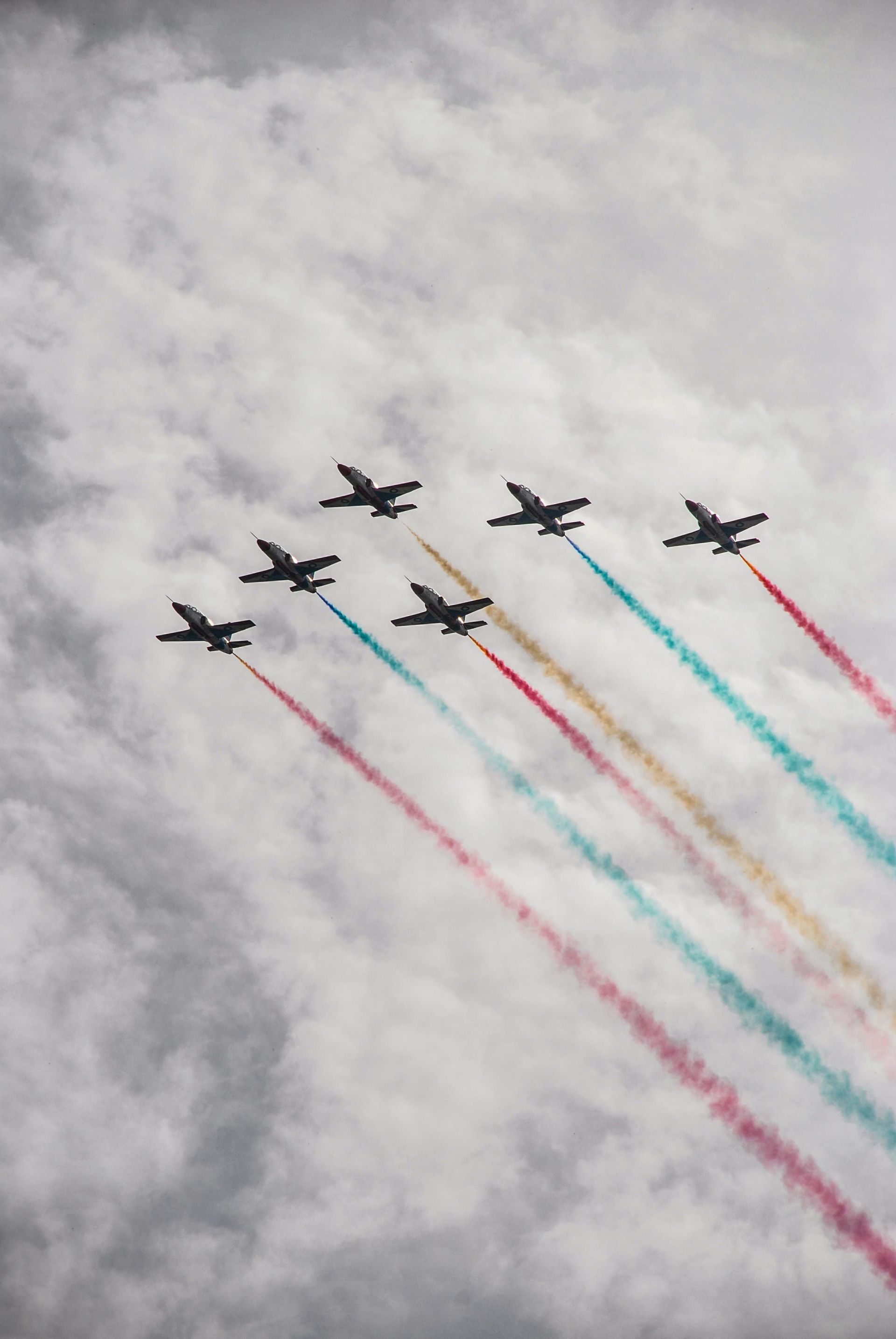 A row of fighter jets are flying in formation in the sky.