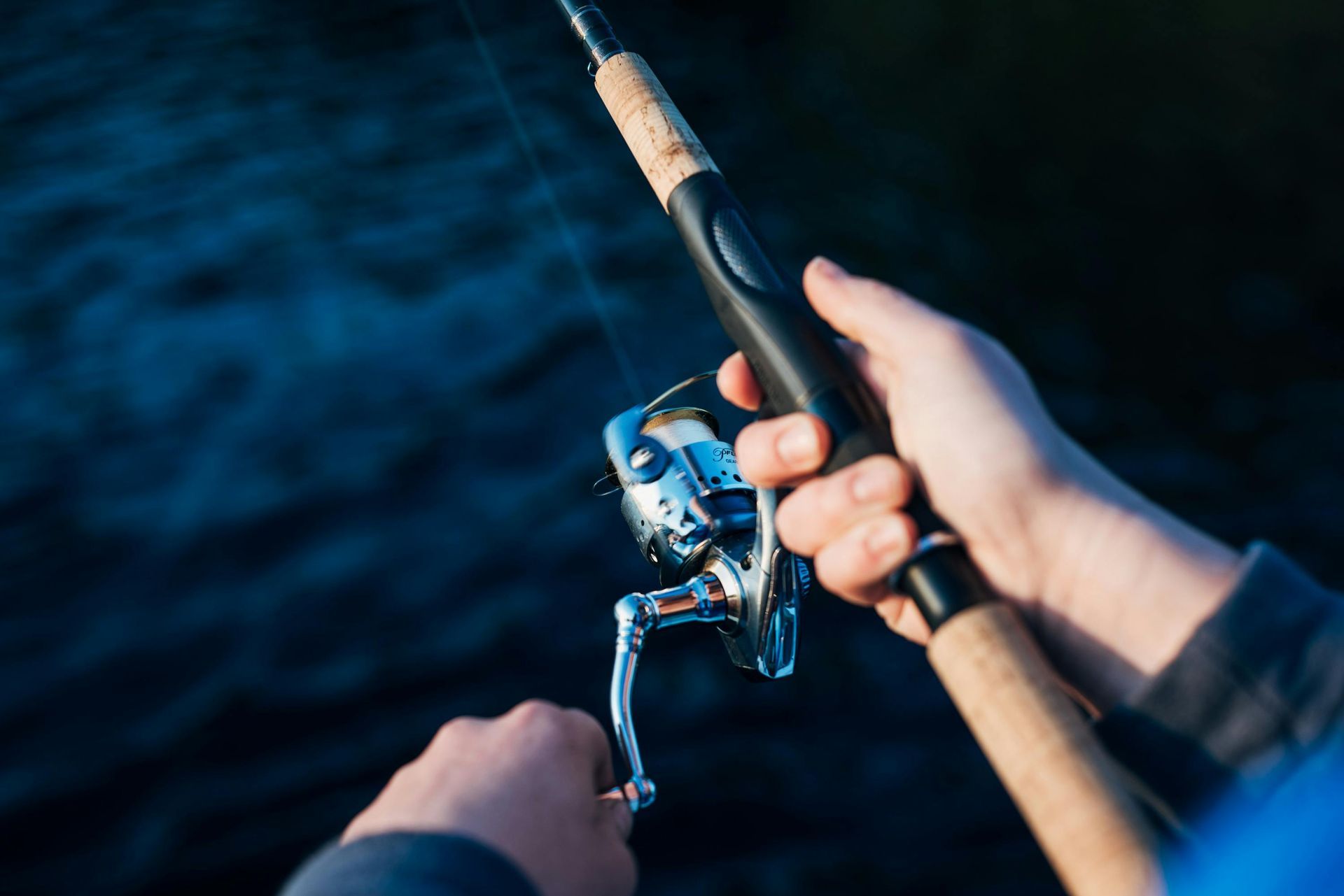 A person is holding a fishing rod in their hands.