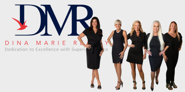 A group of women are standing in front of a fountain.