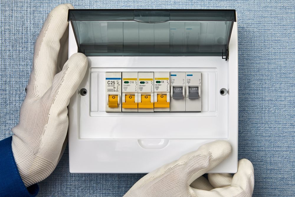 Hands In White Gloves Opening An Electrical Panel — Quik Fire Electrical in Kelmscott, WA