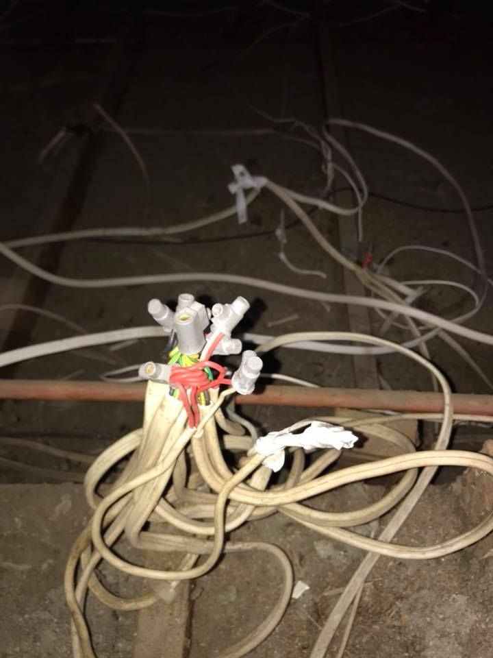 Tangled Beige Cords and Wires on a Dark Floor — Quik Fire Electrical in Kelmscott, WA