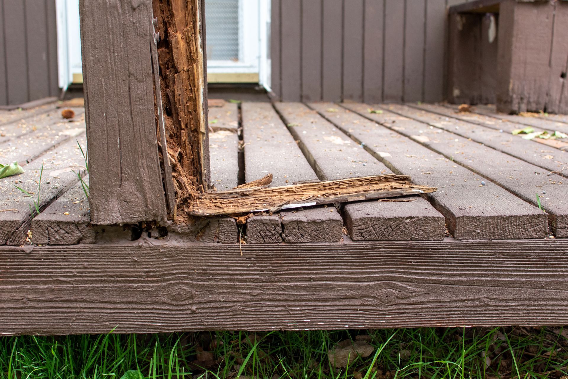 Rotting deck post and boards with damaged wood.