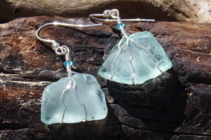Sea glass and sterling silver earrings on charred driftwood by FG Crafts and Jewellery