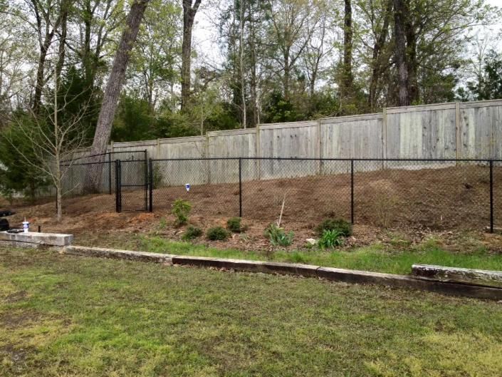 chain link fence with  privacy fence in background