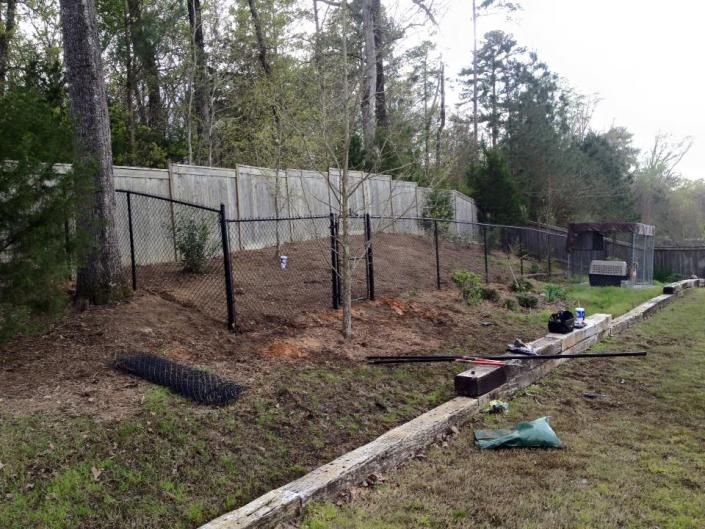 chain link fence with privacy fence in background