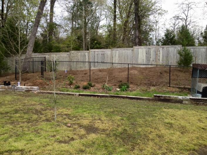 chain link fence with privacy fence in background