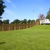 privacy fence on side of yard with white home