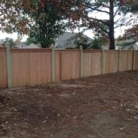 privacy fence with tree with in the background
