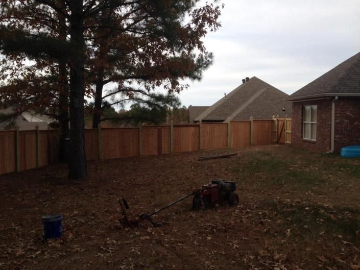 privacy fence on side of brick home