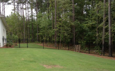 iron fence on side of white house