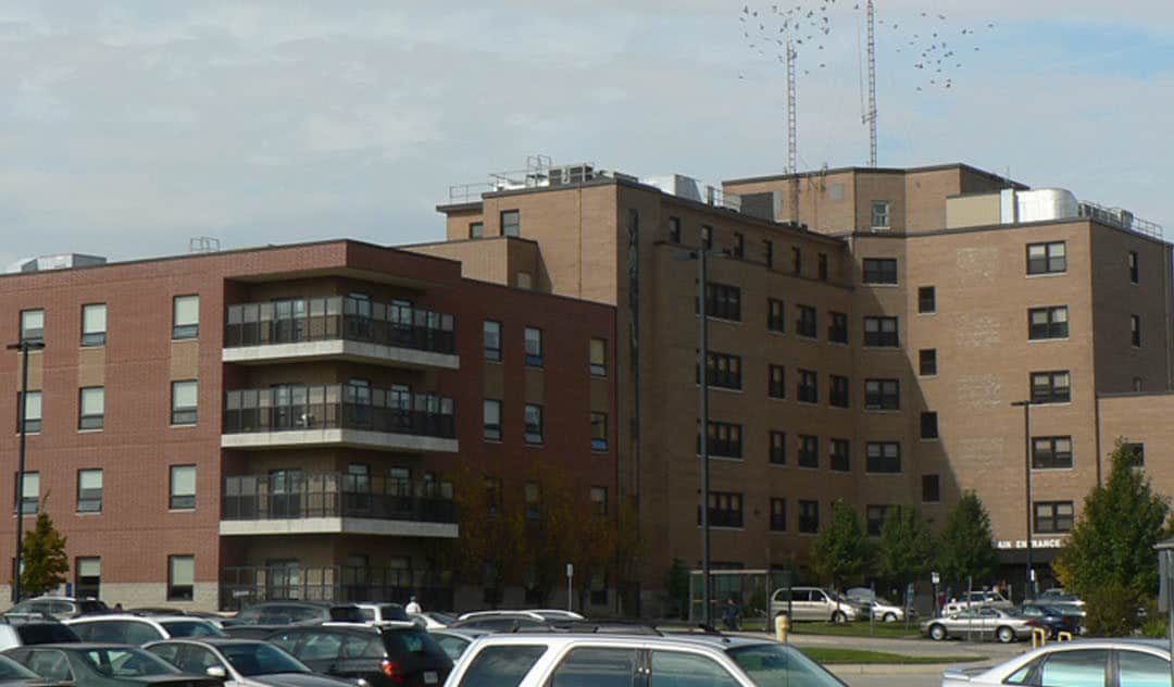 A large brick building with cars parked in front of it