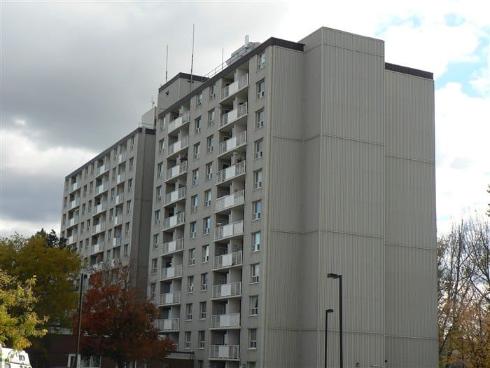A tall building with a lot of windows and balconies