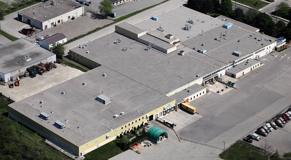 An aerial view of a large building with a lot of cars parked in front of it.