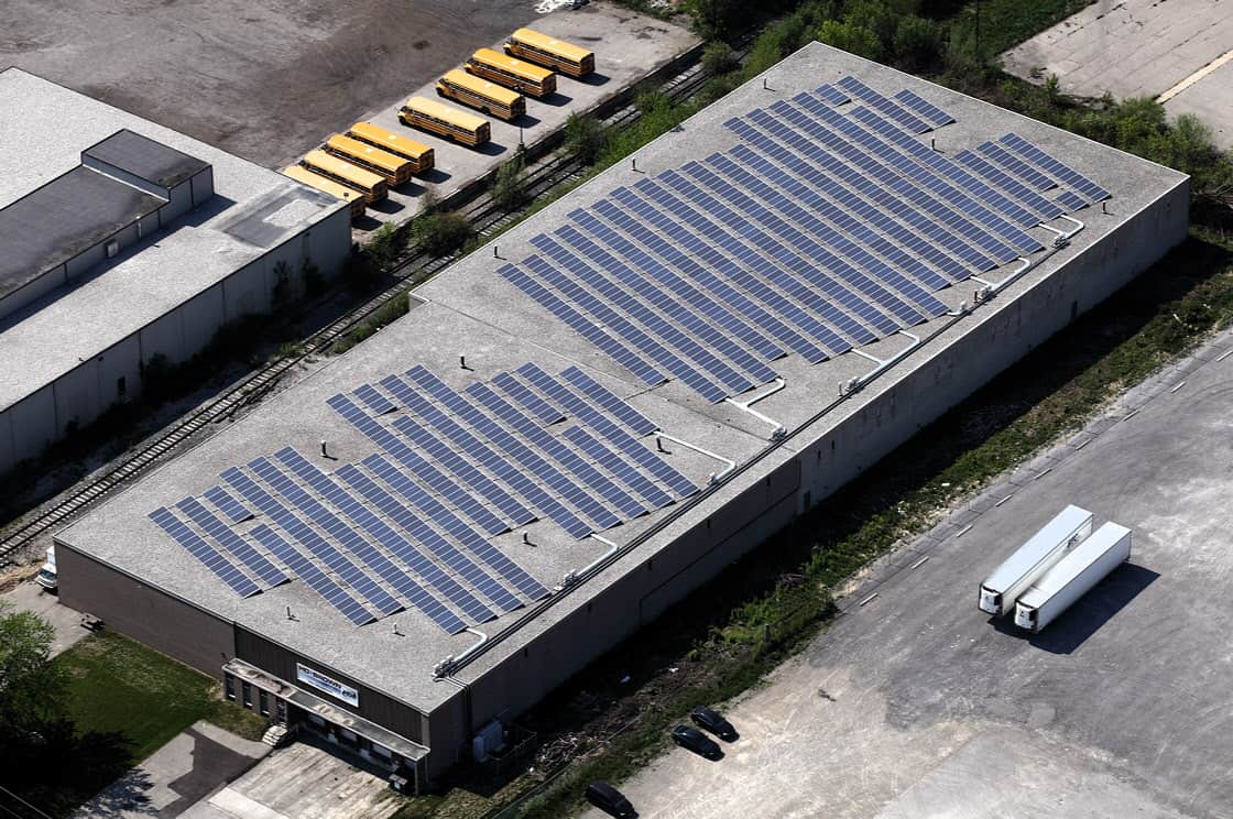 An aerial view of a building with solar panels on the roof