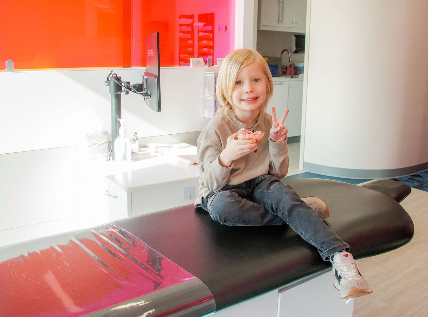 A young boy is having his teeth examined by a dentist.